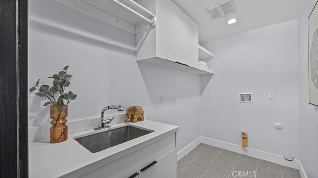 laundry area featuring cabinets, sink, washer hookup, and hookup for a gas dryer