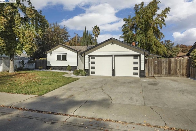 view of front of home with a front yard and a garage