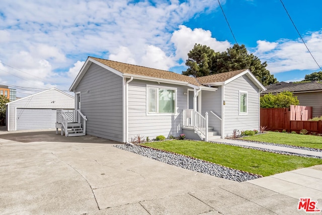 view of front of house with a front lawn, an outdoor structure, and a garage