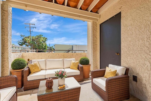 view of patio / terrace with a balcony and an outdoor hangout area