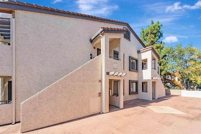 view of side of home featuring a patio area