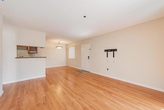 unfurnished living room with light wood-type flooring