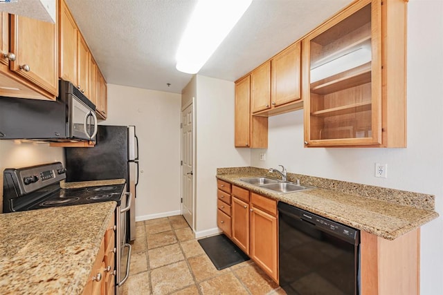 kitchen featuring a textured ceiling, light stone counters, sink, and stainless steel appliances