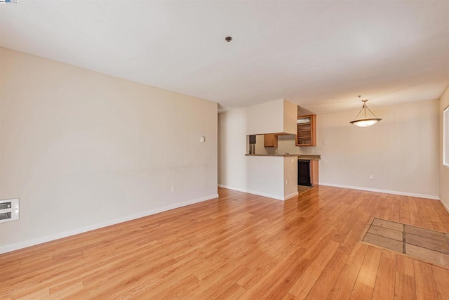 unfurnished living room with light wood-type flooring