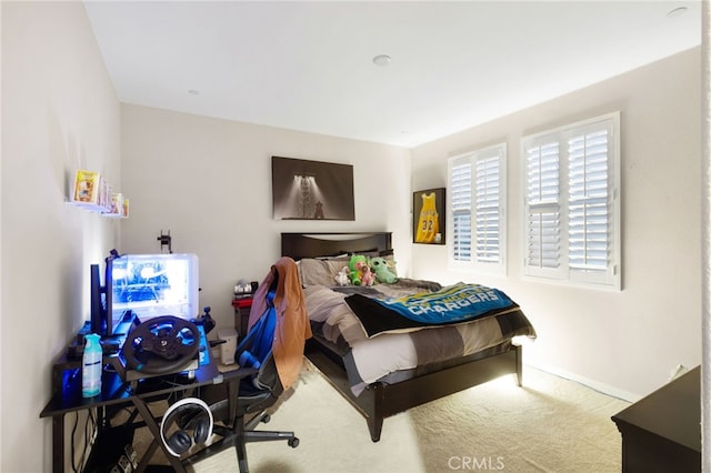 bedroom featuring light colored carpet