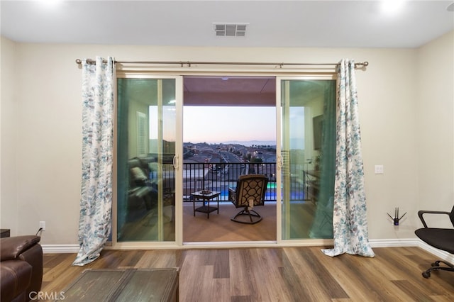 doorway to outside with wood-type flooring