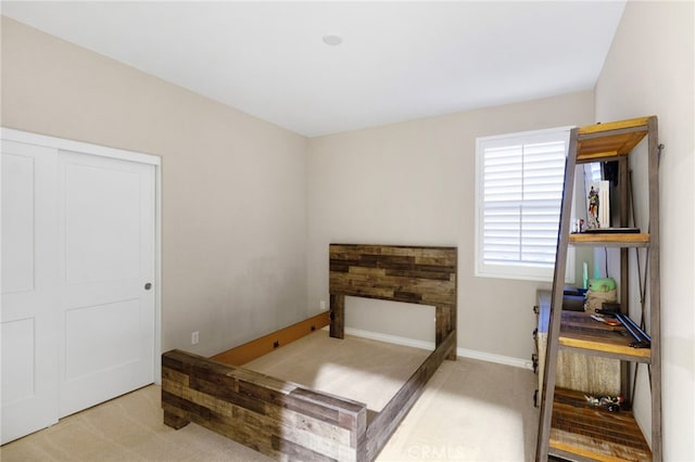 bedroom with light carpet and a closet