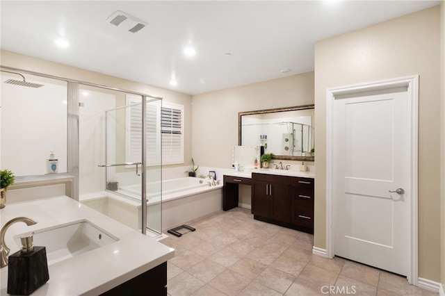 bathroom featuring tile patterned flooring, vanity, and plus walk in shower