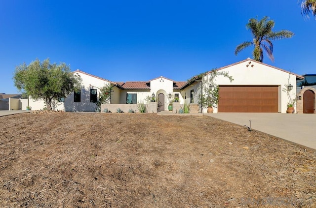 mediterranean / spanish-style home featuring a garage