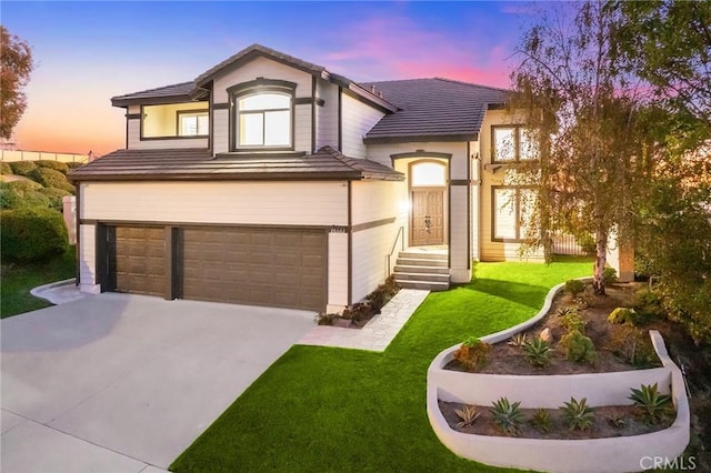 view of front of house with a yard and a garage