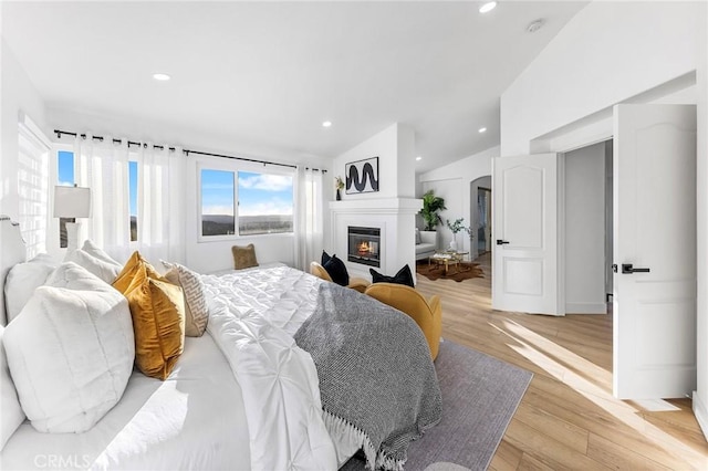 bedroom featuring light hardwood / wood-style flooring and vaulted ceiling