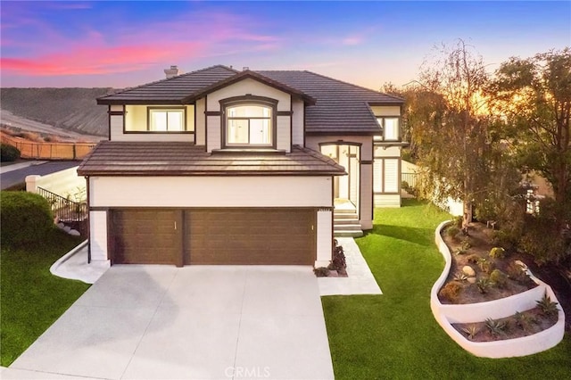 view of front of home featuring a lawn and a garage