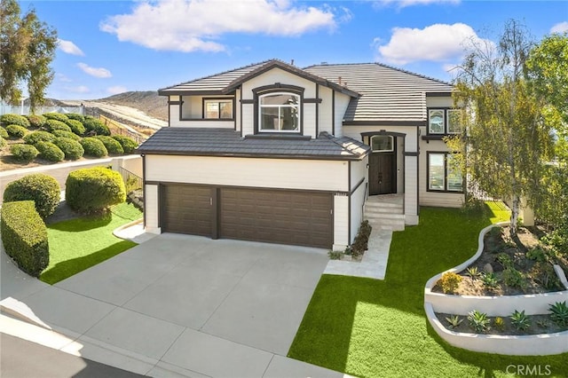 view of front facade featuring a front lawn and a garage