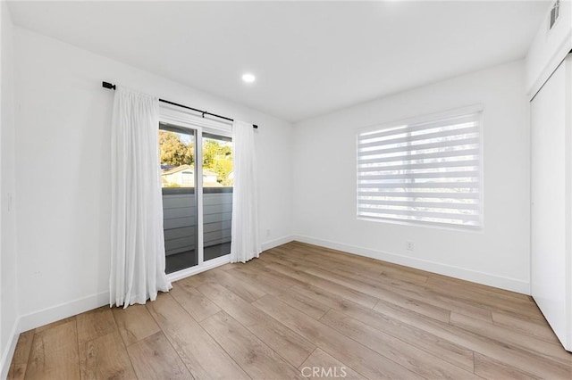 unfurnished room with light wood-type flooring