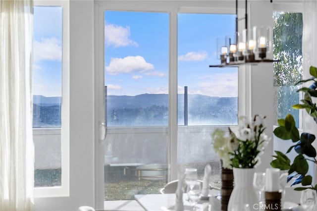 dining area with a mountain view and an inviting chandelier