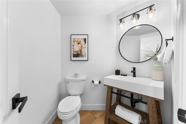 bathroom with hardwood / wood-style flooring and toilet