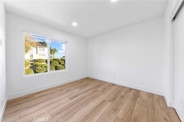 unfurnished room with light wood-type flooring