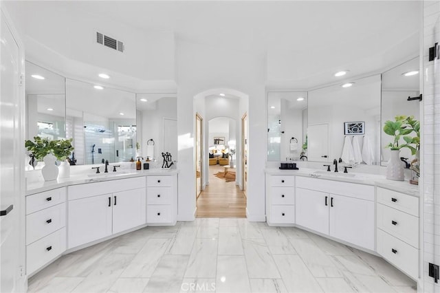 bathroom with vanity and a shower with shower door