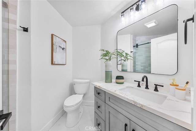 bathroom featuring tile patterned floors, vanity, toilet, and a tile shower