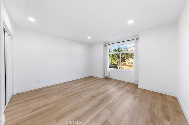 empty room with light hardwood / wood-style flooring