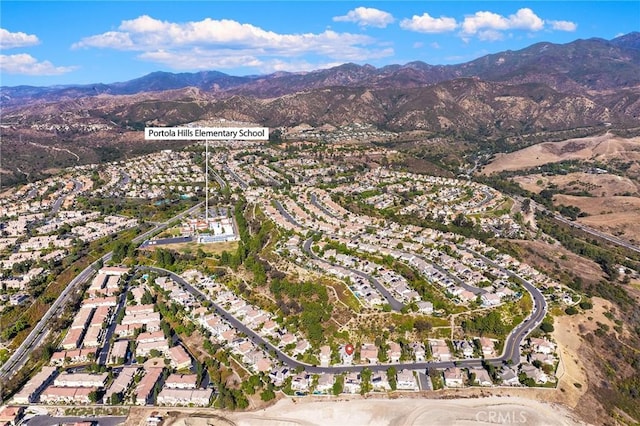 birds eye view of property featuring a mountain view