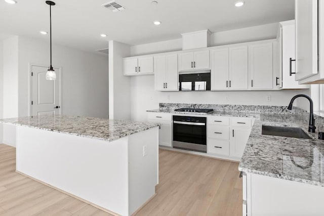 kitchen featuring white cabinets, a center island, and stainless steel appliances