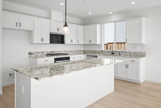 kitchen featuring white cabinetry, pendant lighting, and a kitchen island