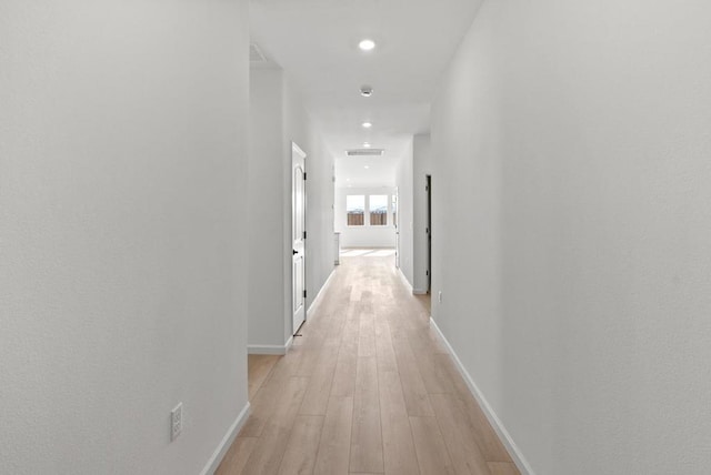 hall with light hardwood / wood-style flooring