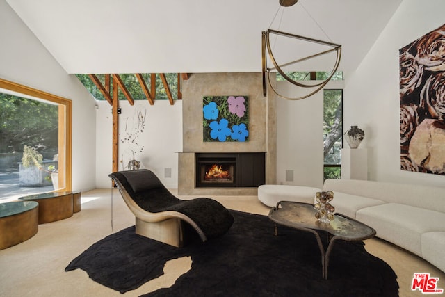 living room with carpet, a large fireplace, and lofted ceiling