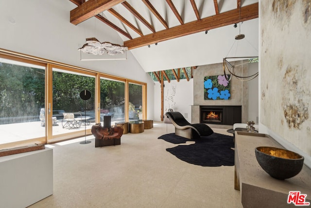 living room featuring beamed ceiling, concrete flooring, and high vaulted ceiling