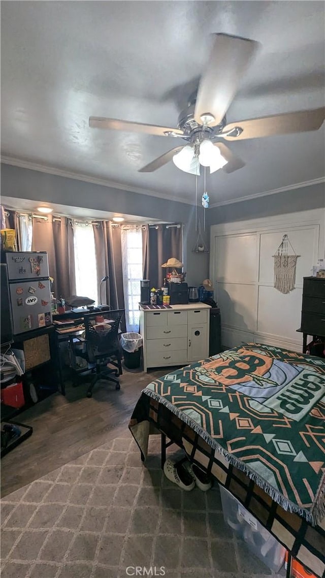 bedroom featuring hardwood / wood-style floors, ceiling fan, and ornamental molding