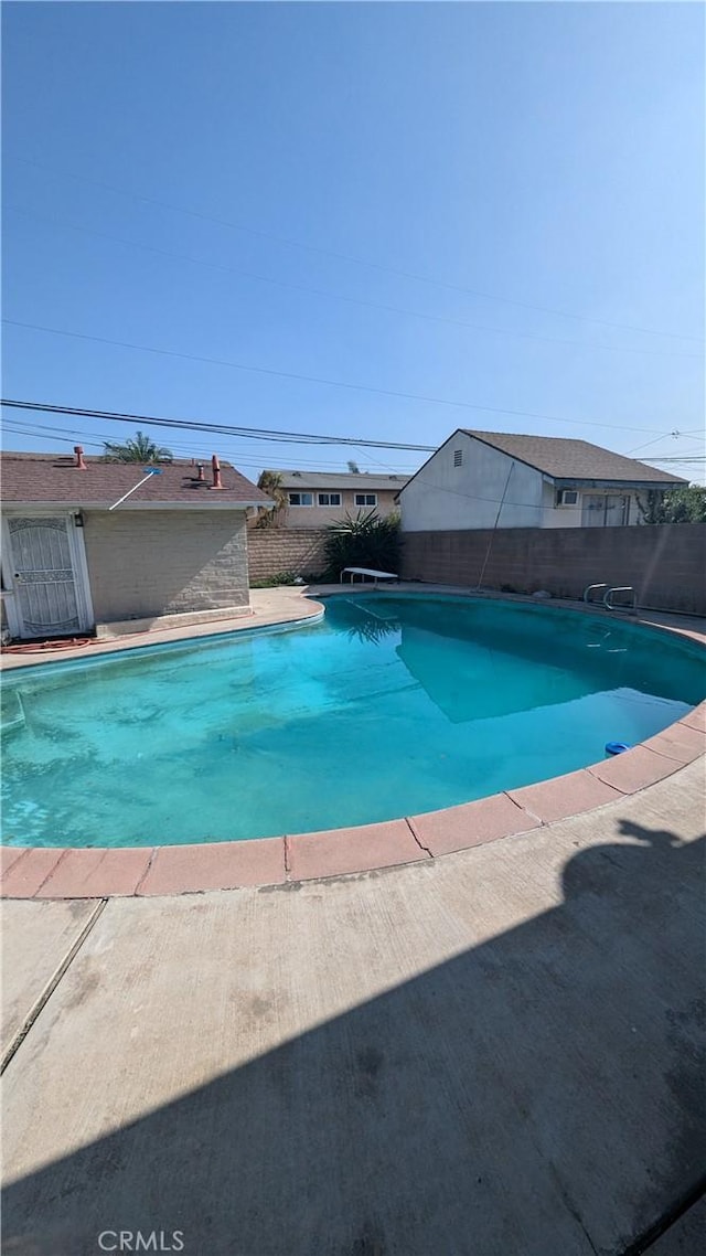 view of pool with a diving board