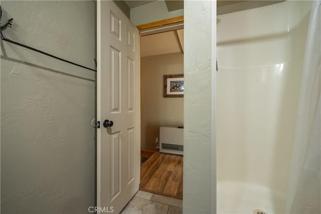 bathroom featuring hardwood / wood-style floors and walk in shower