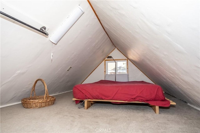 carpeted bedroom featuring lofted ceiling