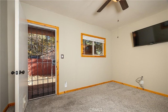 spare room featuring carpet flooring and ceiling fan