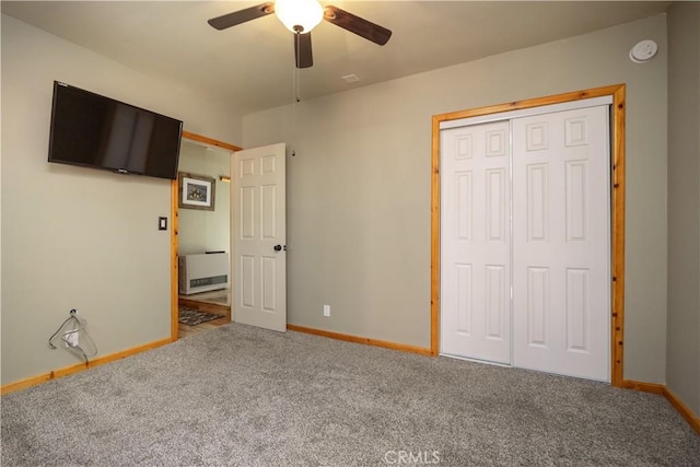 unfurnished bedroom featuring carpet floors, a closet, and ceiling fan