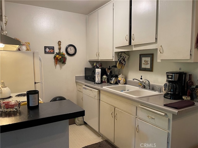 kitchen with white appliances, white cabinetry, and sink