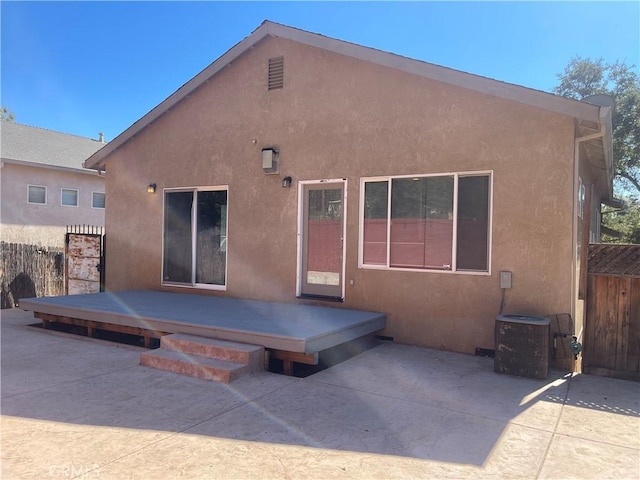 back of house featuring a patio area, a deck, and central AC