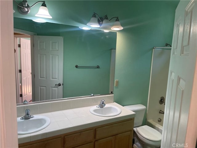 full bathroom with vanity, toilet, and washtub / shower combination