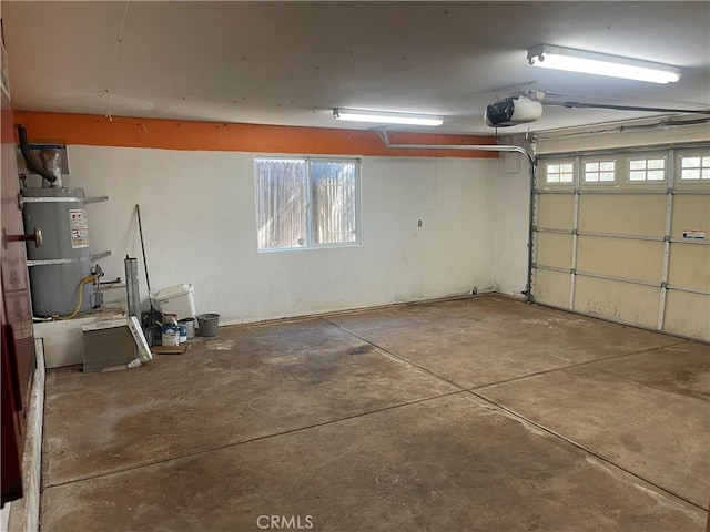 garage featuring strapped water heater and a garage door opener