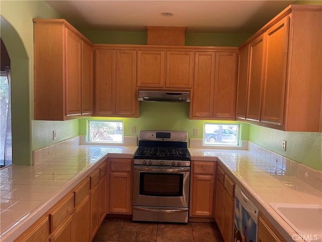 kitchen featuring tile counters, plenty of natural light, and appliances with stainless steel finishes