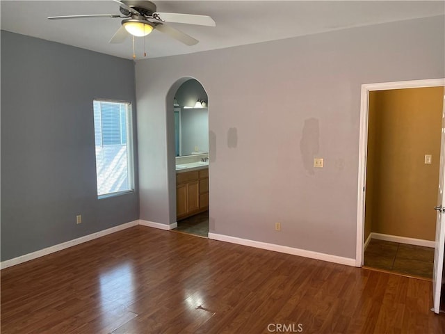 unfurnished room featuring ceiling fan and dark wood-type flooring