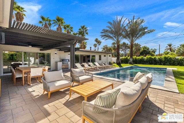 view of pool with exterior kitchen, a pergola, outdoor lounge area, and a patio area