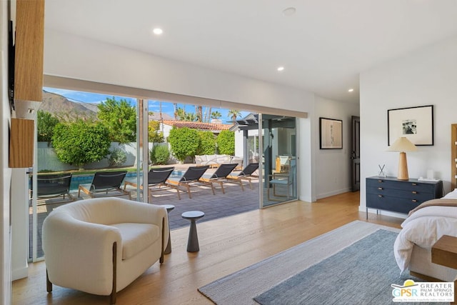 bedroom featuring access to exterior and light hardwood / wood-style flooring