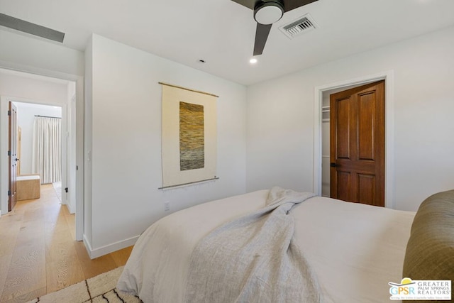 bedroom with ceiling fan and light hardwood / wood-style floors