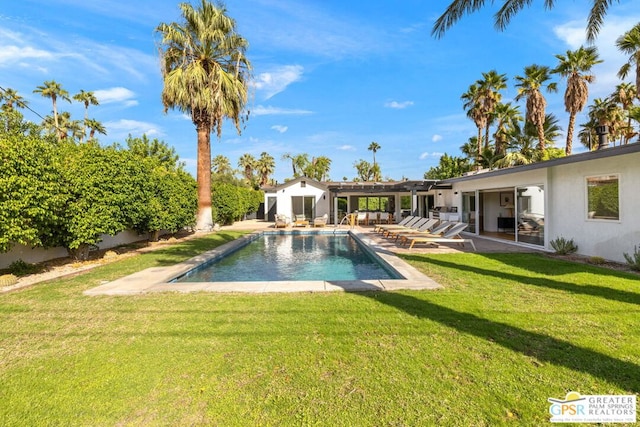 view of swimming pool with a yard and a patio