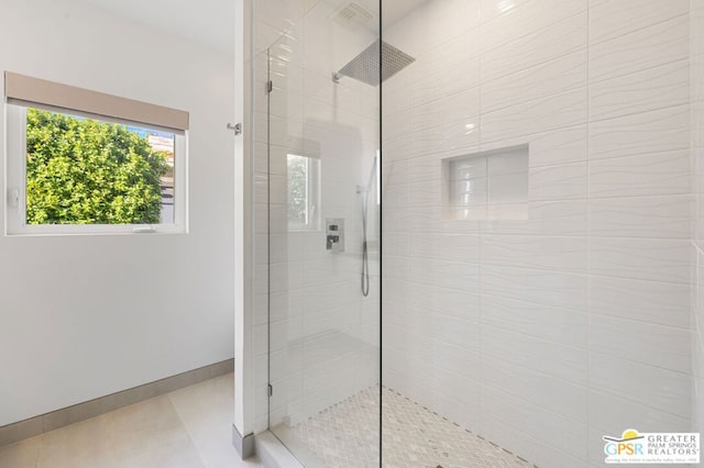 bathroom with tile patterned flooring and tiled shower