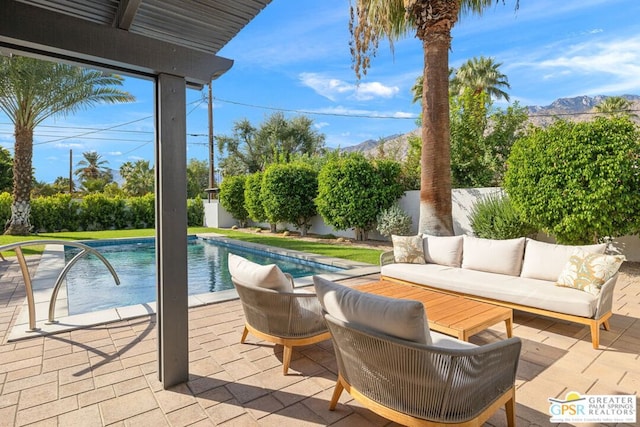 view of swimming pool featuring a mountain view, a patio area, and outdoor lounge area