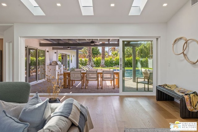 living room with a wealth of natural light and light hardwood / wood-style flooring