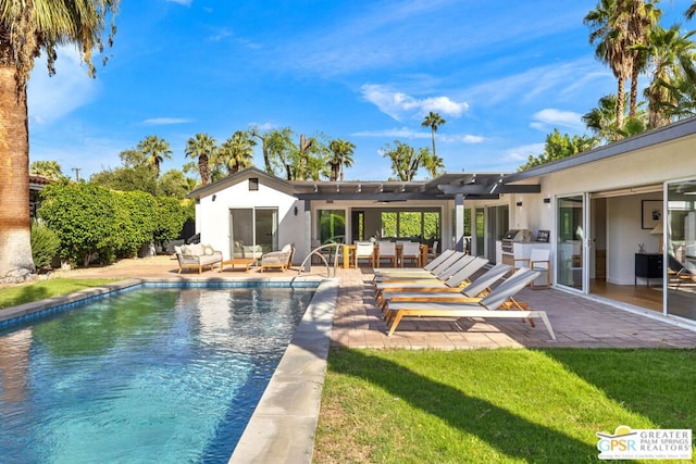 back of house featuring a patio, outdoor lounge area, a yard, and a pergola